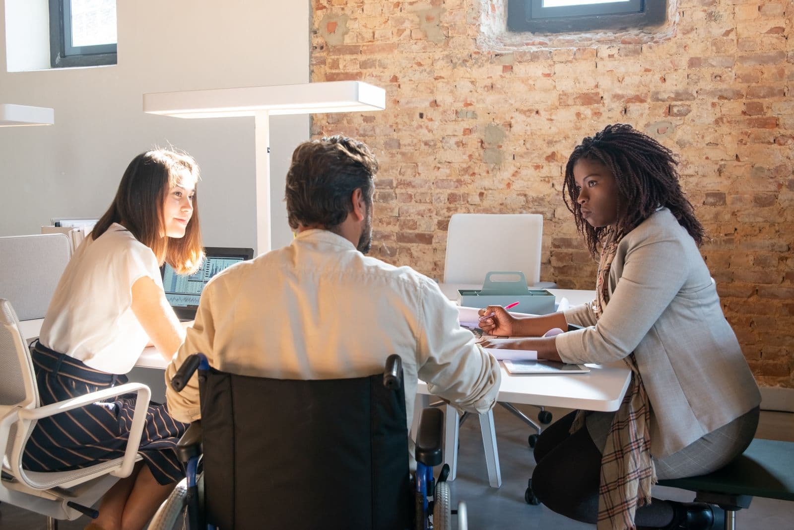 Two people talking across a desk